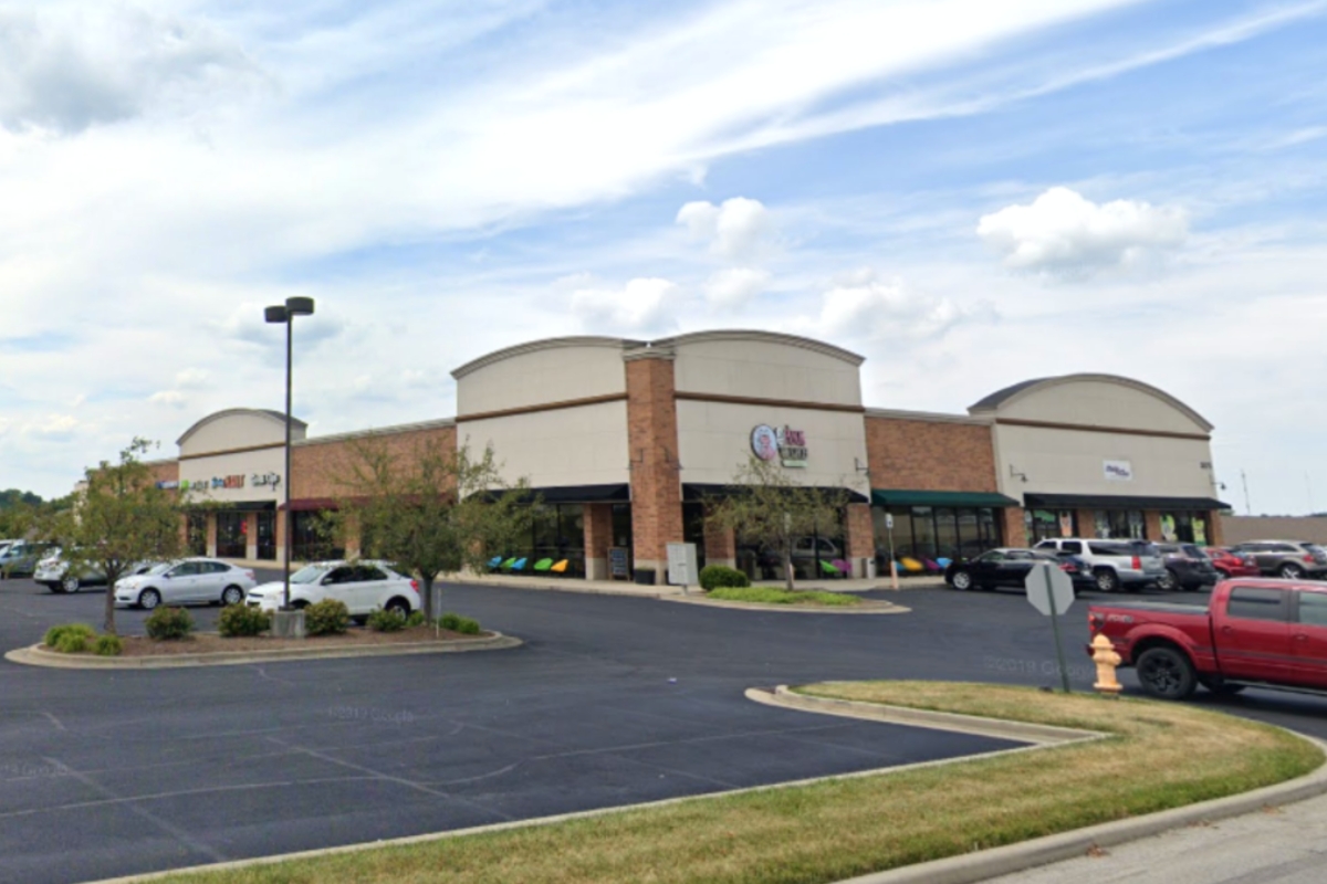 shopping center with cars parked in front