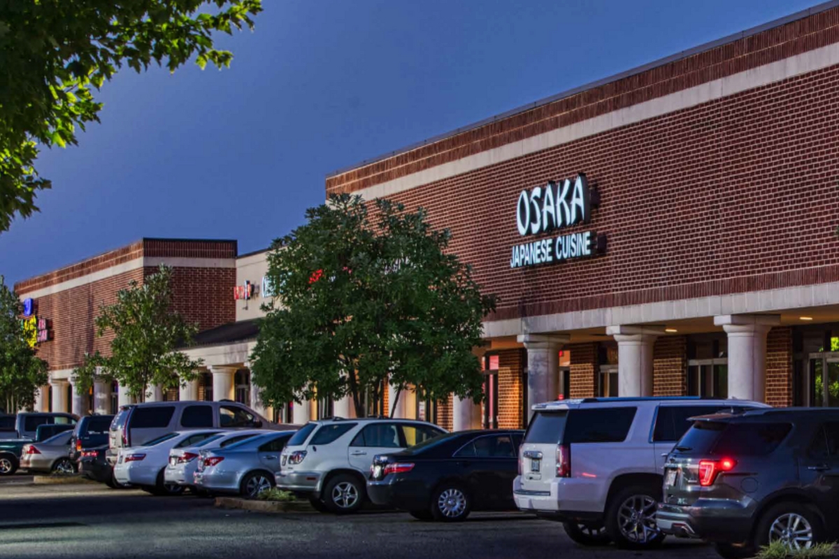 shopping center with cars parked in front