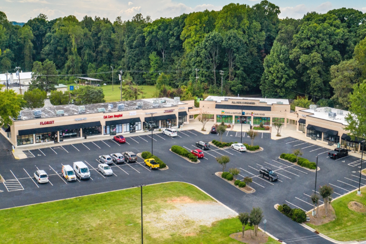 aerial view of shopping center with cars parked in front