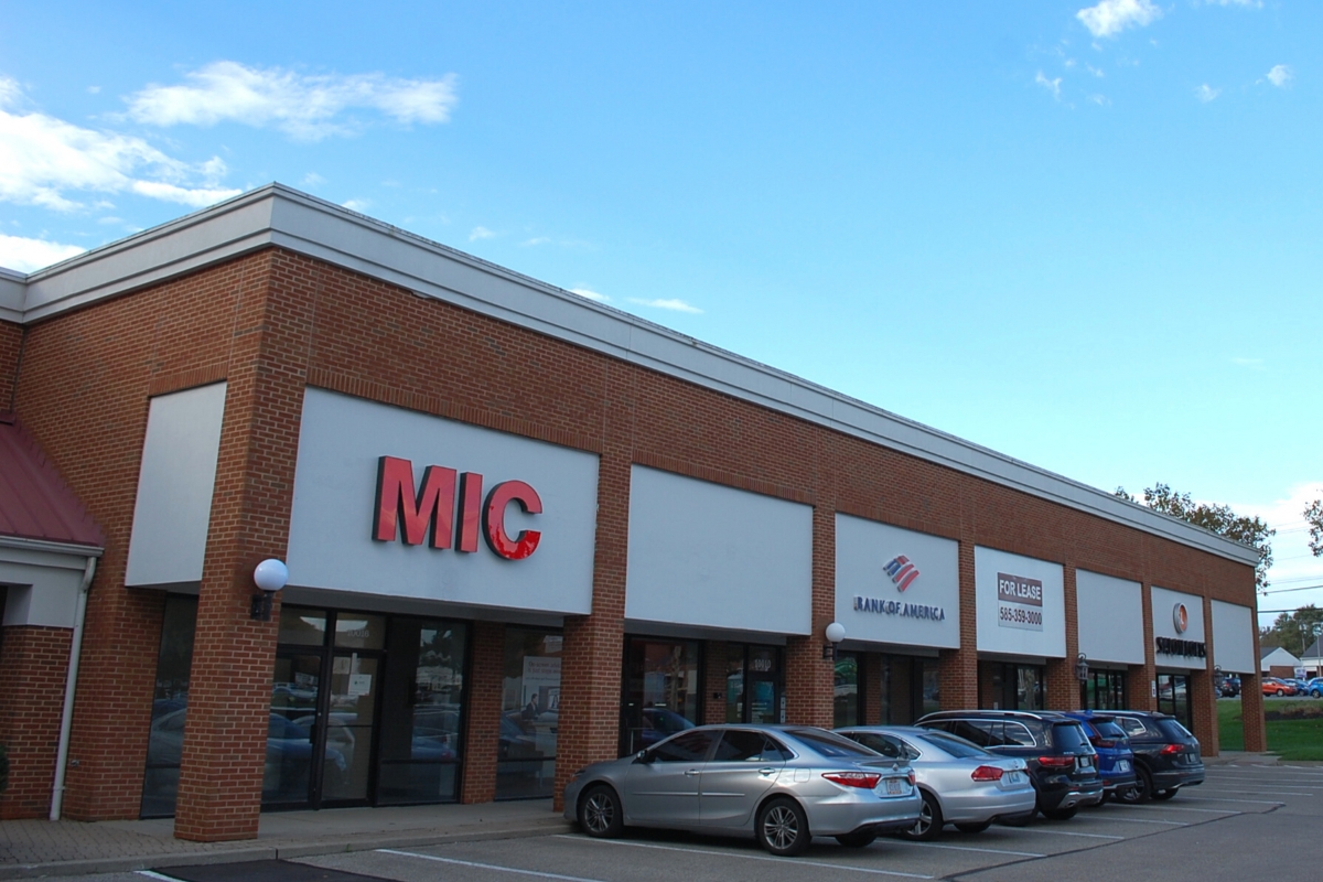 shopping center with cars parked in front