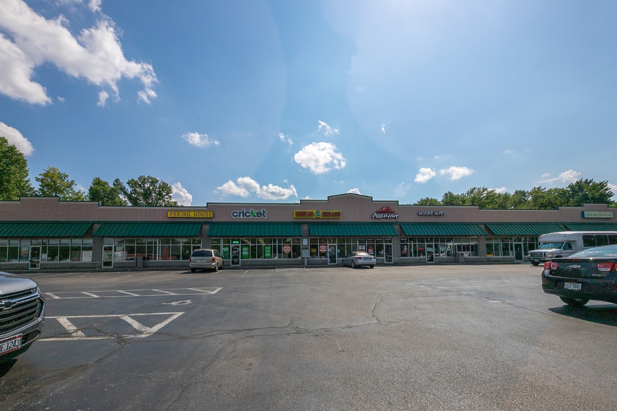 shopping center with cars parked in front